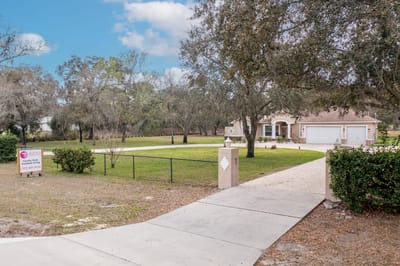 Outside view of Aliviya Rose Manor with landscaped grounds