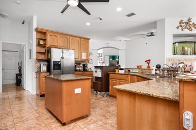 Bright kitchen area with wooden cabinets and granite countertops