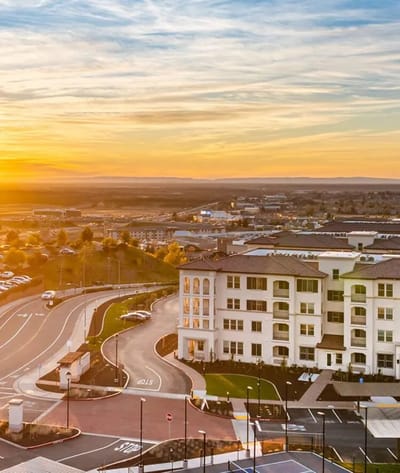 Aerial view of a senior living facility at sunset