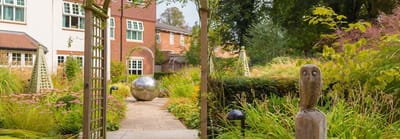 Well-maintained garden with sculptures in a care home