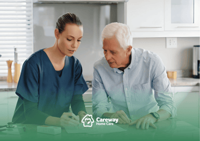 Nurse assisting a senior man at a table