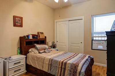 A private resident room with a bed and shelf