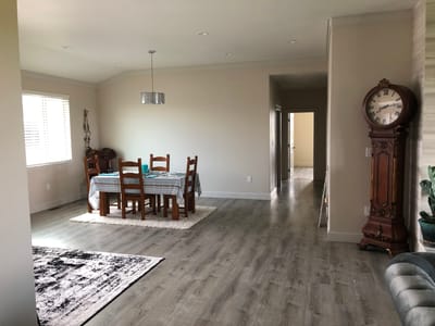 Bright common area with dining table and clock