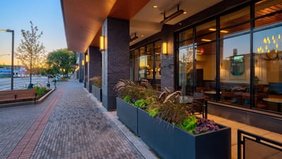 Exterior view of the facility with planters and sidewalk