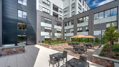 An outdoor seating area with tables and umbrellas