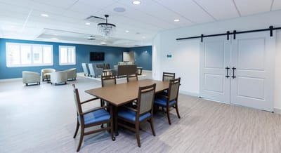 Bright and spacious common area with a dining table