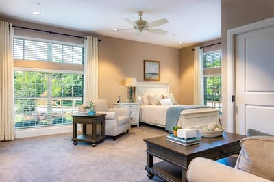 Bright and inviting resident bedroom with large windows