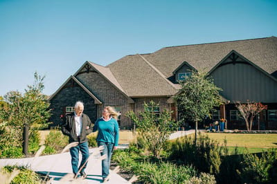 Residents walking outside the assisted living facility