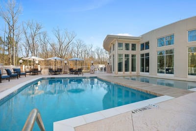 Outdoor pool area with lounge chairs and umbrellas