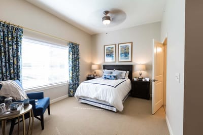 Bright private resident room with bed and decor