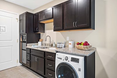 Laundry area with appliances and fruit bowl