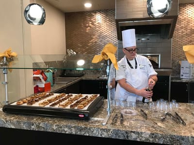 Chef preparing appetizers in a dining area