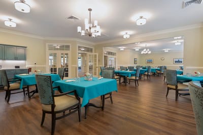 Bright dining room with teal tables and chairs