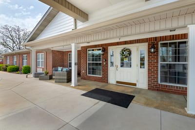 Entrance of a senior living facility with seating