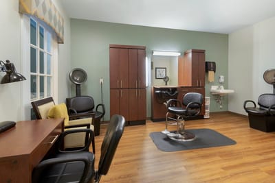 Hair salon area with styling chairs and mirrors
