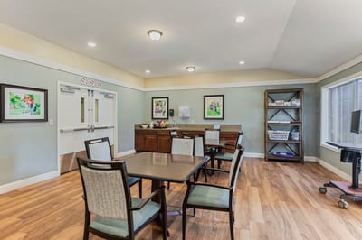 Bright common area with tables and artwork
