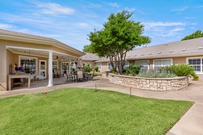 Outdoor patio area with seating and landscaping