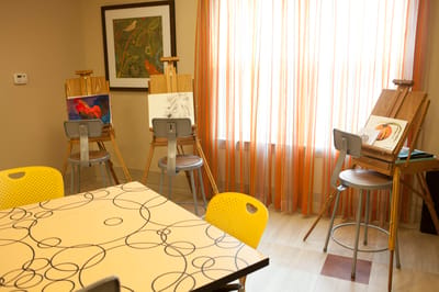 Activity area for residents with easels and artwork