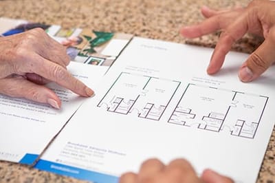 Residents reviewing floor plans together