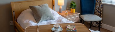 Cozy bedroom in assisted living facility with a bedside table