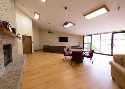 Bright common area with seating and large windows