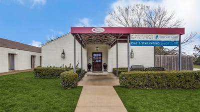 Front entrance of Ennis Care Center with landscaping