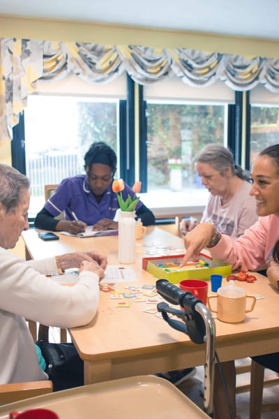 Residents engaging in a craft activity at a table