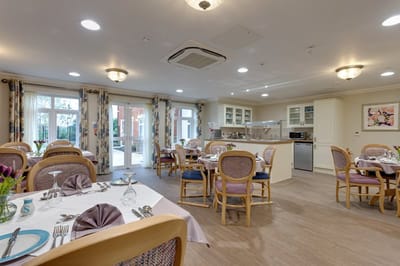 Bright dining room with tables set for meals