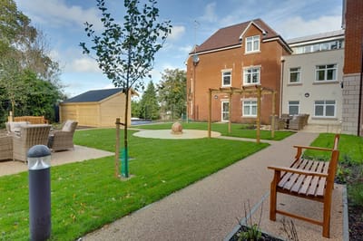 Outdoor space with well-maintained garden and benches