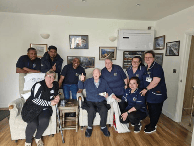 Staff and residents enjoying time together in a lounge
