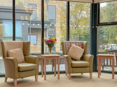 Interior view of cozy chairs and flowers in a common area