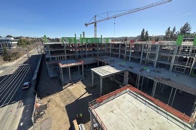Construction site of a new facility with crane and scaffolding