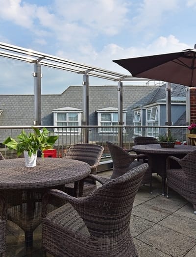 Outdoor terrace area with seating and plants
