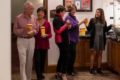 Residents enjoying popcorn at a movie night event
