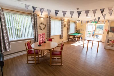 Common area with tables and chairs decorated for an event
