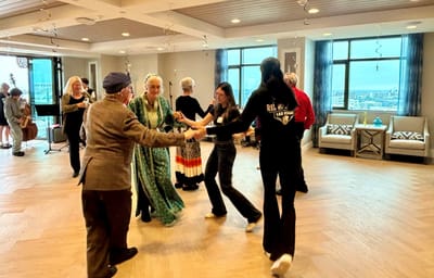 Residents dancing in a vibrant common area