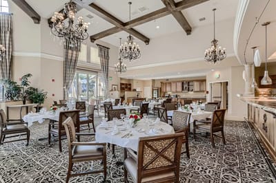 Elegant dining room setup with chandeliers and tables