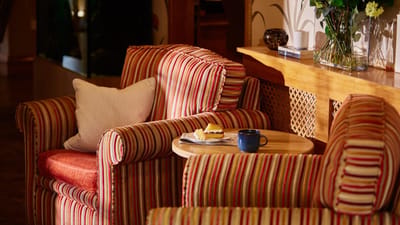 Cozy seating area with cake and coffee on a table