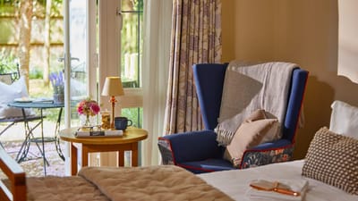 Cozy resident room with outdoor view and comfortable chair
