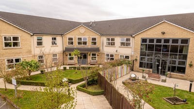 Exterior view of the assisted living facility with garden area