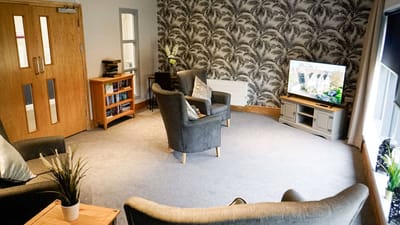 Common area with seating and television.