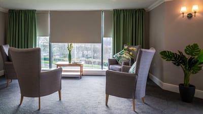 Bright common area with chairs and greenery