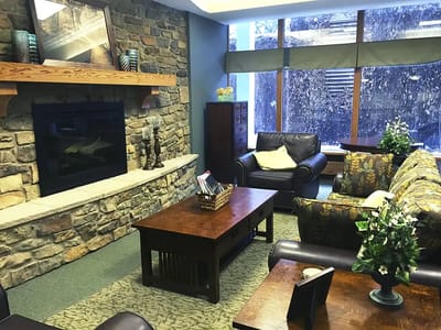 Cozy common area with stone fireplace and seating