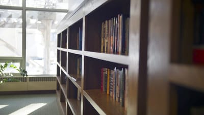 Bookshelf in a common area with natural light
