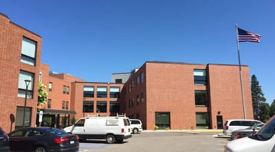 Exterior view of a senior living facility with parking area