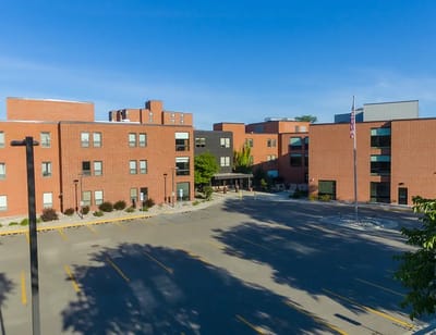 Aerial view of the building with parking lot and flagpole