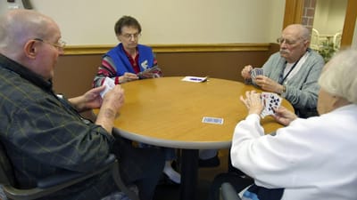 Residents playing cards in a common area