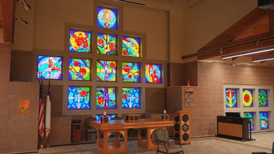 Interior view of a common area with stained glass windows