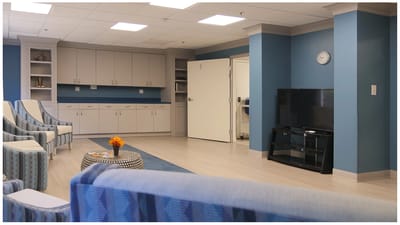 Bright common area with seating and a TV
