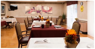 Dining area prepared for a meal with flower arrangements